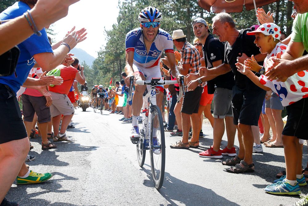 Thibaut Pinot climbs through the crowds during stage 14.