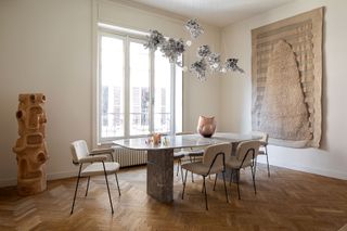 Milanese dining room interior with bocci silver light installation over the table