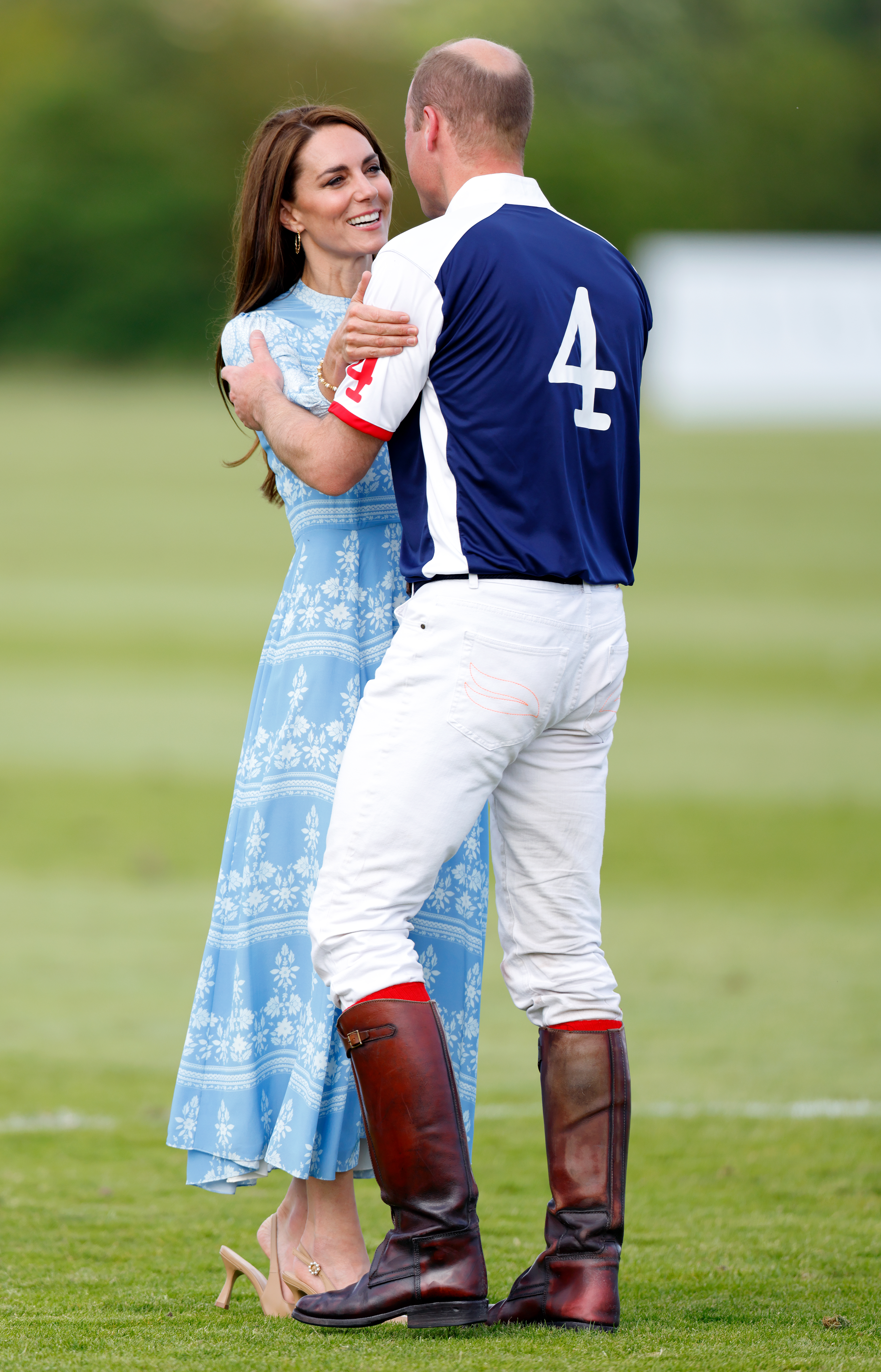 Princess Kate hugging Prince William on a polo field