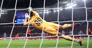 Manchester United target Diogo Costa of FC Porto saves a penalty kick from Kerem Demirbay (obscured) of Bayer Leverkusen during the UEFA Champions League group B match between Bayer 04 Leverkusen and FC Porto at BayArena on October 12, 2022 in Leverkusen, Germany.