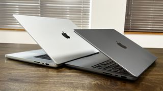 MacBook Pro 2021 14 inch and 16 inch next to each other, slightly open and angled