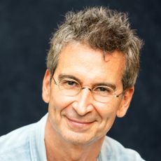 Frederico Marchetti wearing a denim shirt and glasses