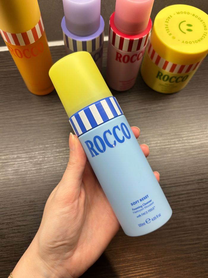 Deputy beauty editor Grace Lindsay holding the Rocco Soft Reset Foaming Cleanser