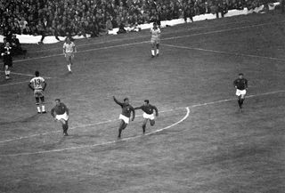 Eusebio celebrates after scoring for Portugal against Brazil at the 1966 World Cup.