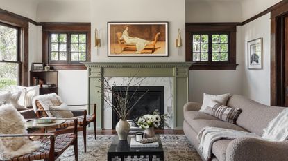 living room with green fireplace and white walls and wood framed windows