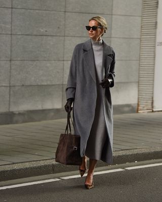 @anoukyve wearing a grey dress and coat with heels