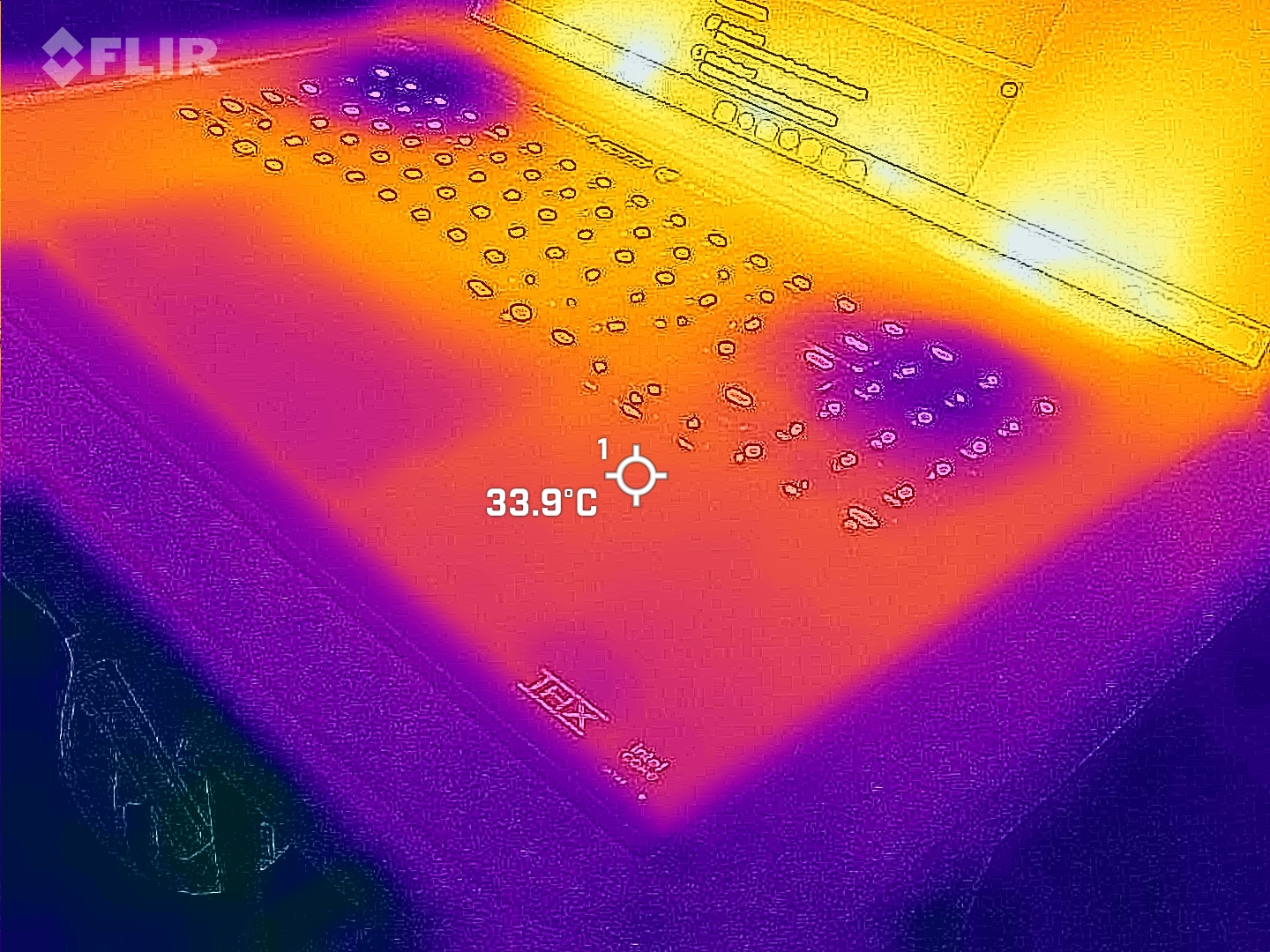Razer Blade 18 (2025) gaming laptop viewed with a FLIR thermal camera showing hot and cool spots