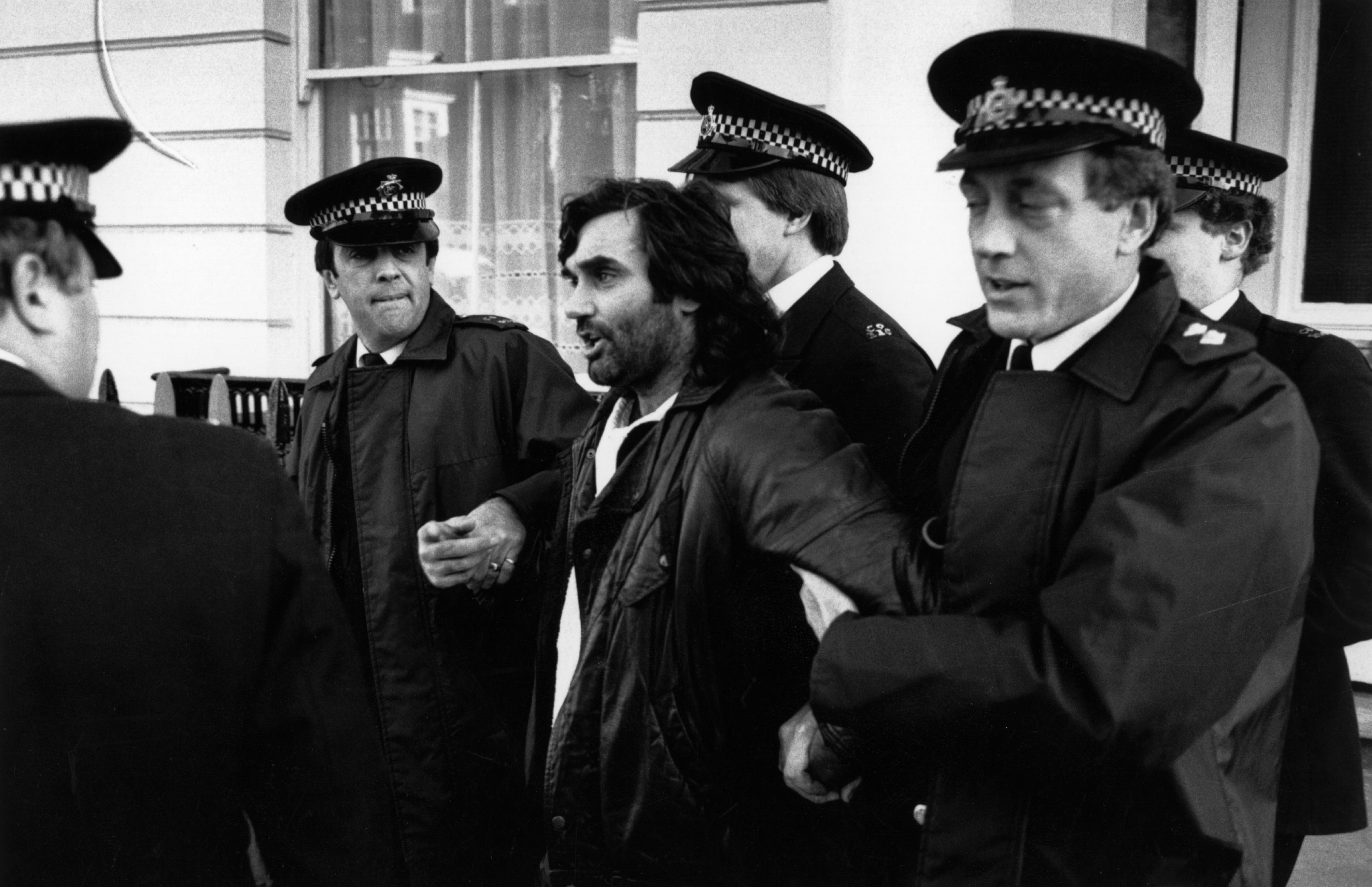 Irish footballer George Best is led away by policemen. He was later accused of drunk driving and assaulting a police officer. (Photo by Express Newspapers/Getty Images)