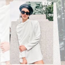 A model wearing a white mini dress, a black hat, and black sunglasses from River Island