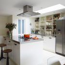 white kitchen with stainless steel worktop and crockery
