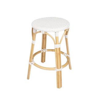A white circular bar stool with light wooden legs and white ties on it