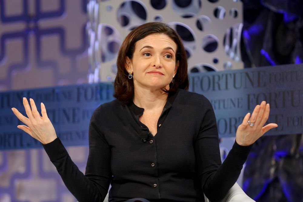 Sheryl Sandberg with hands up