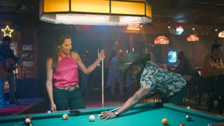 Nikki Estridge and Dion Johnstone as Genevieve and Erik playing pool in Sweet Magnolias season 3