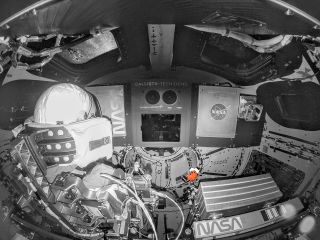 A color-altered photo highlights Snoopy floating aboard NASA's Artemis I Orion spacecraft as the moon mission's "zero-g indicator."