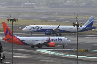 Two IndiGo planes on an airport tarmac