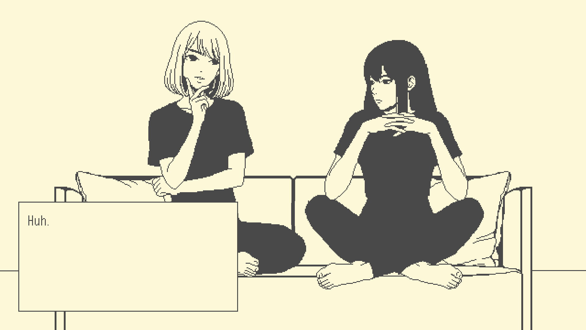 Two women sit cross-legged on a couch