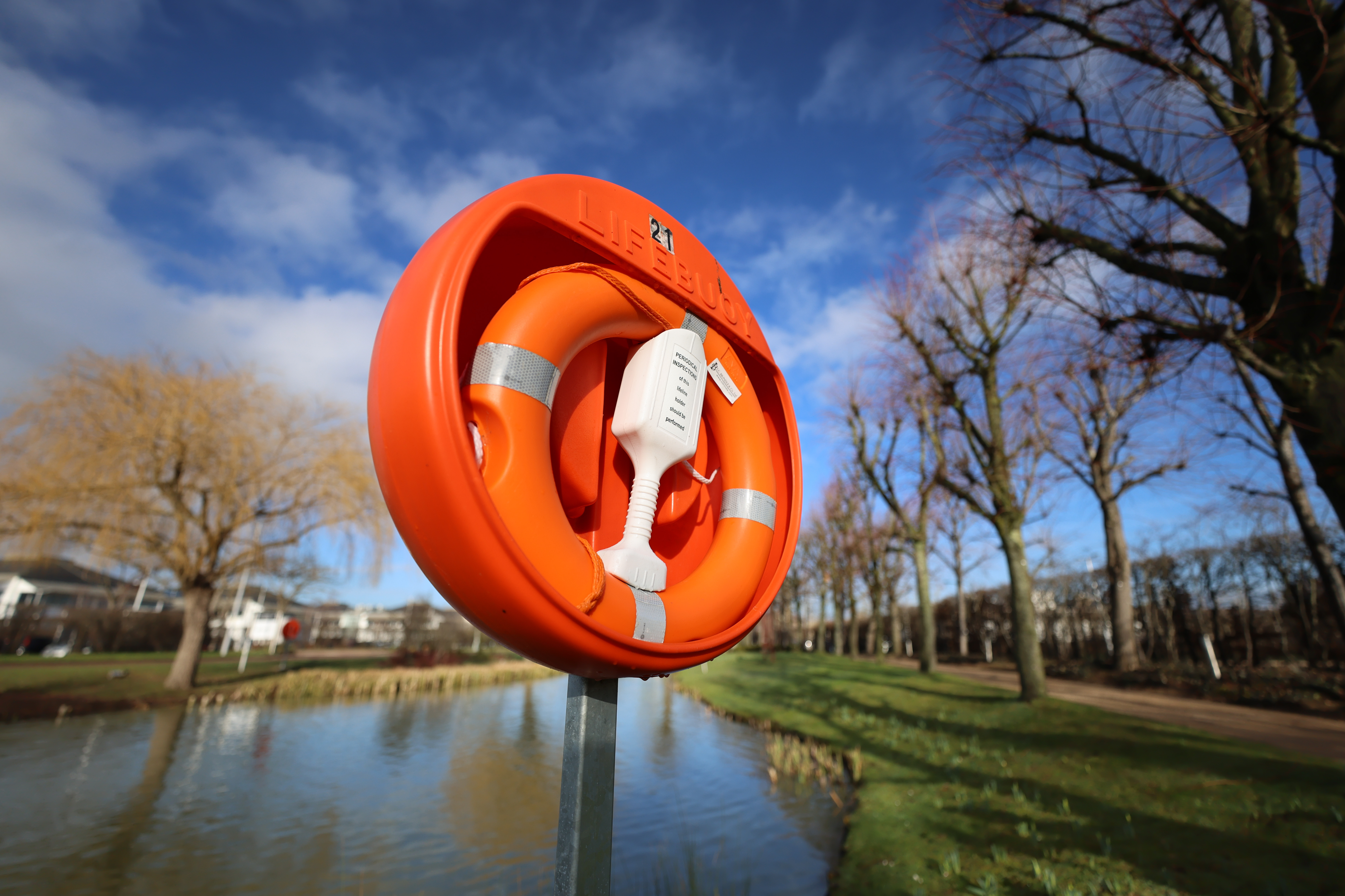 Close-up of an orange life band at the edge of the lake