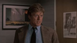 Robert Redford in a tan jacket and a blue shirt in Sneakers