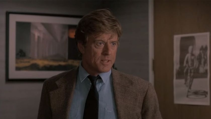 Robert Redford in a tan jacket and a blue shirt in Sneakers