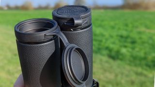 A close up view of the binoculars' objective lens caps