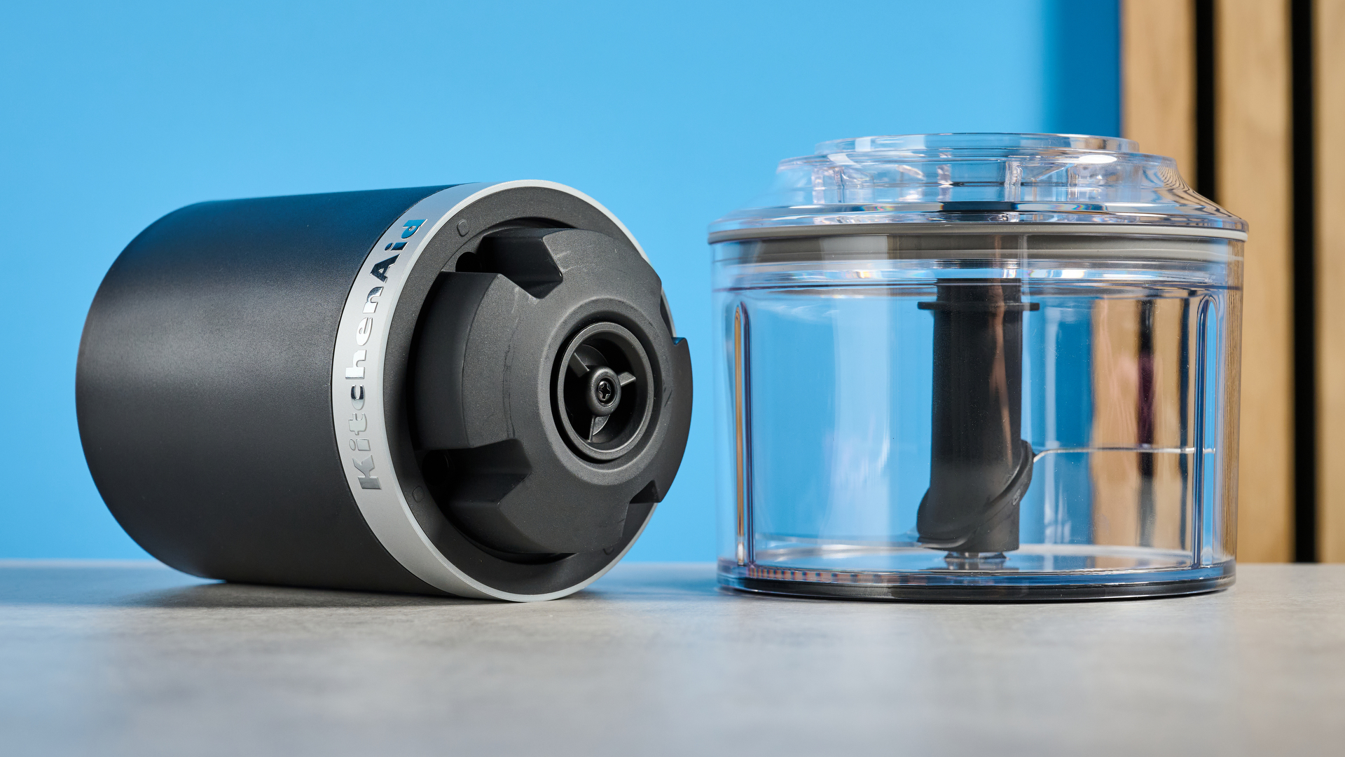 KitchenAid Cordless Top Down Food Chopper photographed in front of a blue background.