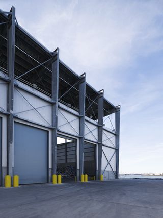 Large warehouse with metal structure and open doors
