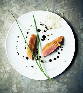 White dinner plate, a food dish neatly presented, grey marble effect surface