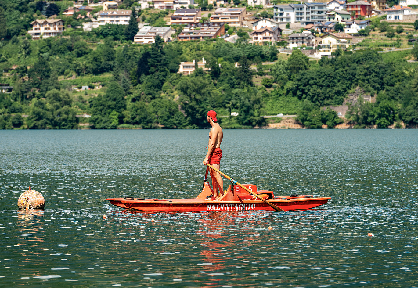 lifeguard in Italy wearing the lifeguard's uniform in red