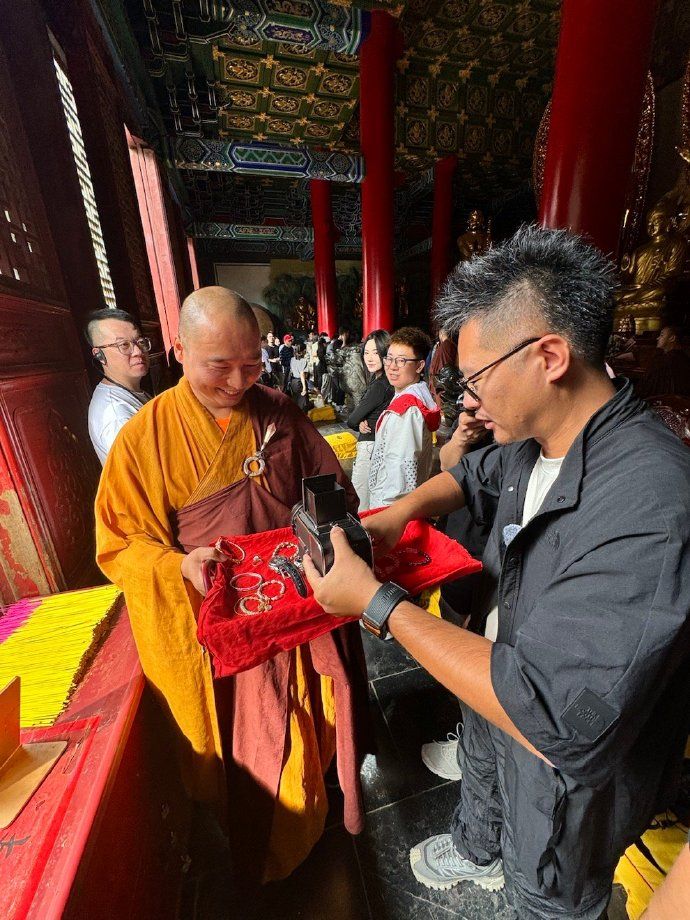 A Buddhist monk blesses a Hasselblad film camera at the Shaolin Temple in Henan, China