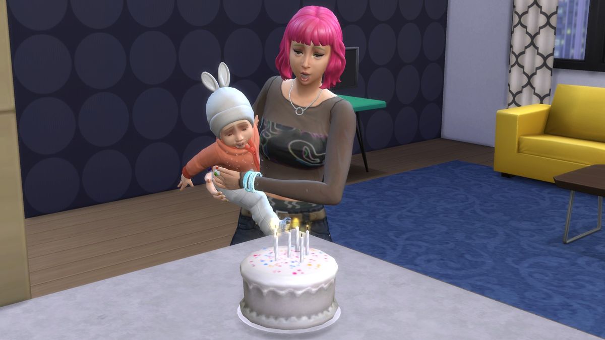 The Sims 4 - An adult Sim holds an infant and helps them blow out birthday candles on a cake.