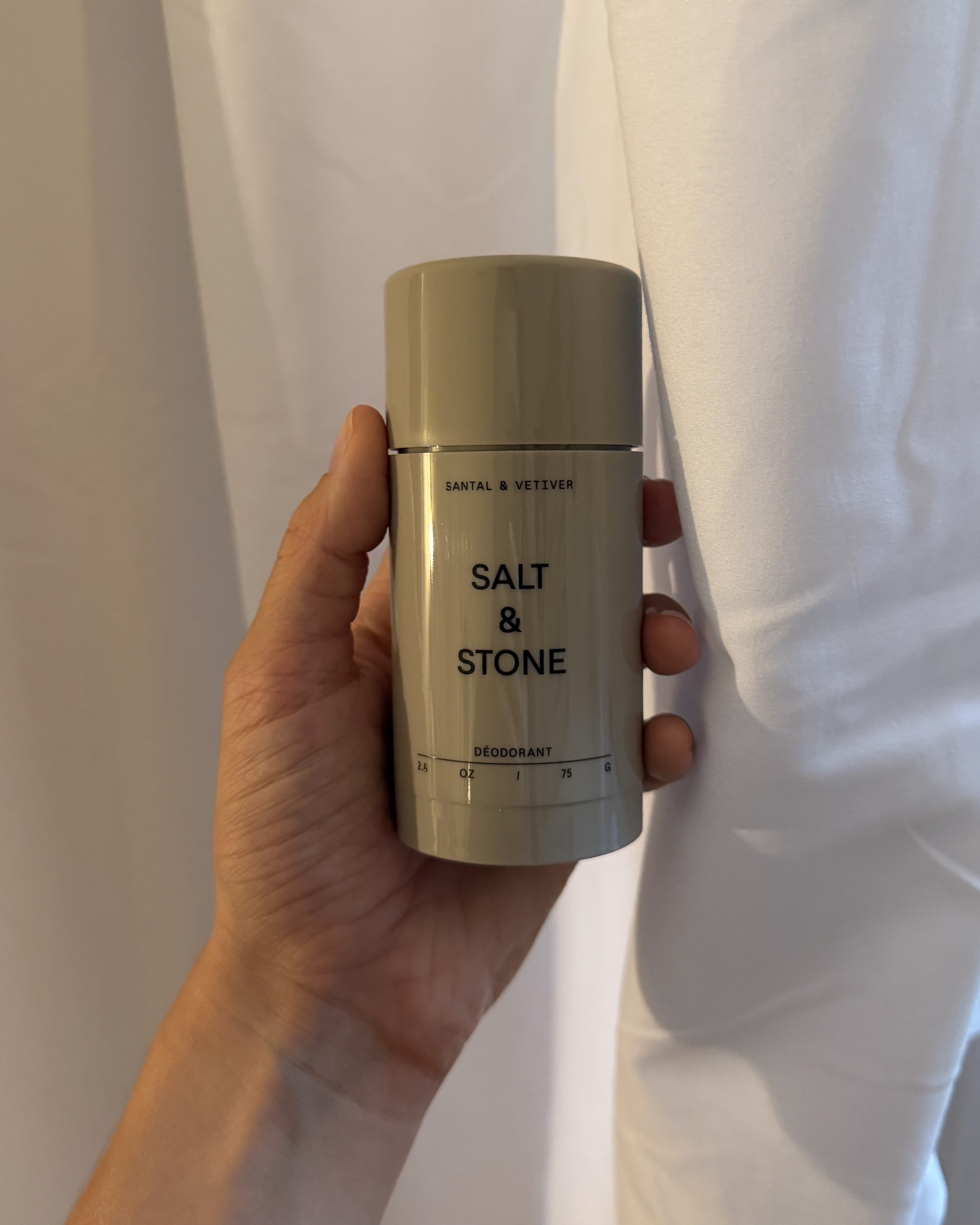 An image of associate beauty editor Alyssa Brascia holding the Salt &amp;amp; Stone Santal &amp;amp; Vetiver Extra-Strength Aluminum-Free Deodorant.