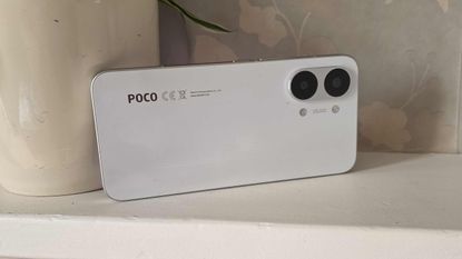 The Poco X8 Pro Max placed horizontally on a ledge.