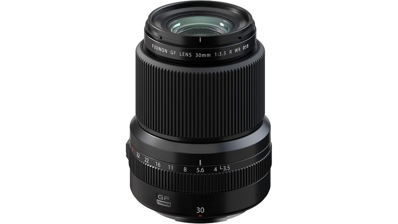The Fujifilm GF 30mm f/3.5 R WR lens standing upright, showing the front lens element