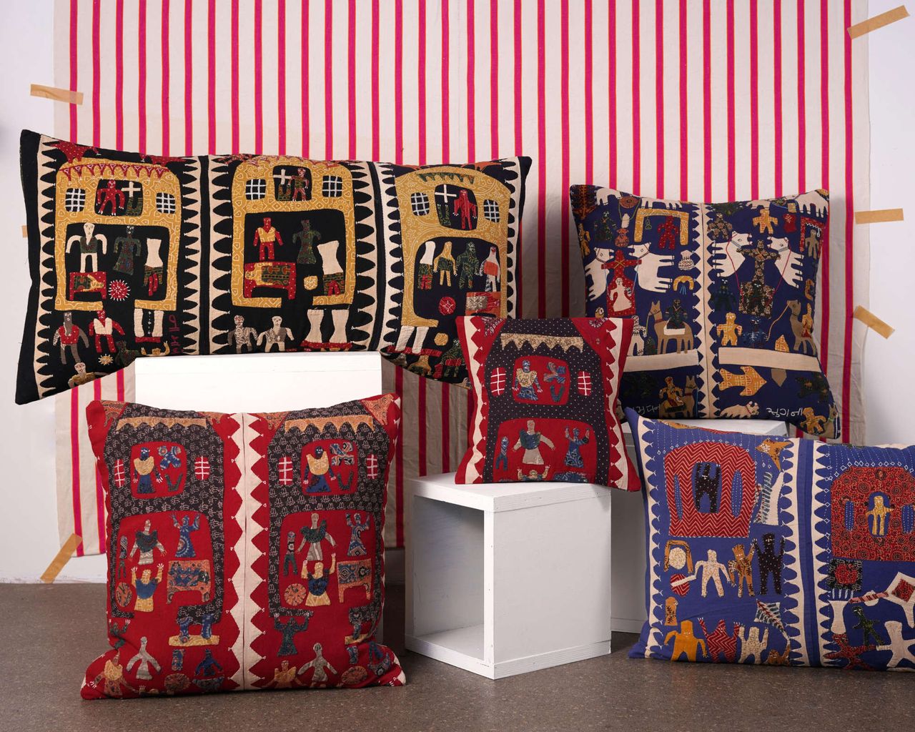 Montes & Clark decorative pillows with red and white striped background
