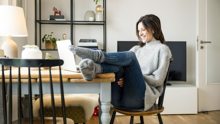 Woman sitting on a chair with her laptop