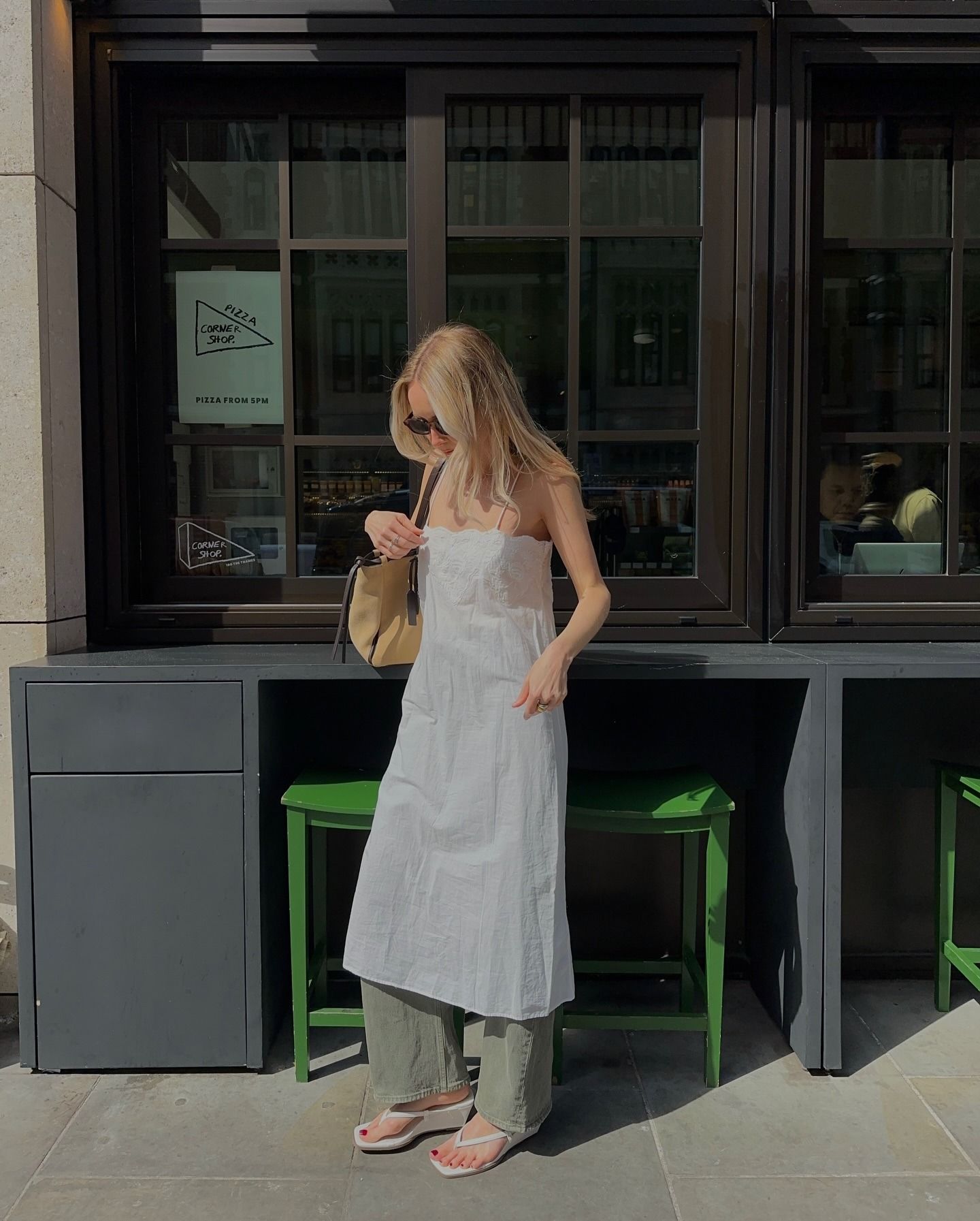 @chloekathbutler wearing colored jeans and wedge sandals.