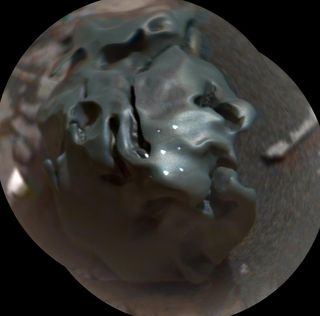 This dark, lumpy, golf ball-size object is an iron-nickel meteorite. NASA's Curiosity rover discovered it on Mars on Oct. 30, 2016.
