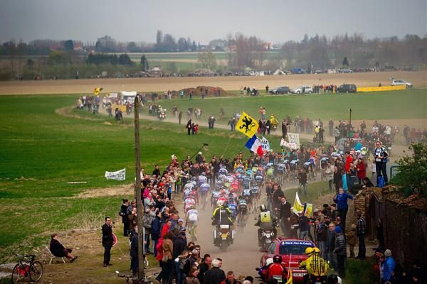 The peloton makes its way through northern France to the Roubaix velodrome on dry roads.