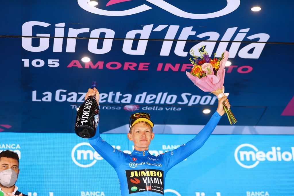 APRICA ITALY MAY 24 Koen Bouwman of Netherlands and Team Jumbo Visma Team Blue Mountain Jersey celebrates at podium during the 105th Giro dItalia 2022 Stage 16 a 202km stage from Sal to Aprica 1173m Giro WorldTour on May 24 2022 in Aprica Italy Photo by Michael SteeleGetty Images