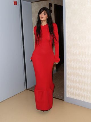 kylie jenner with bangs in a red acne studios dress