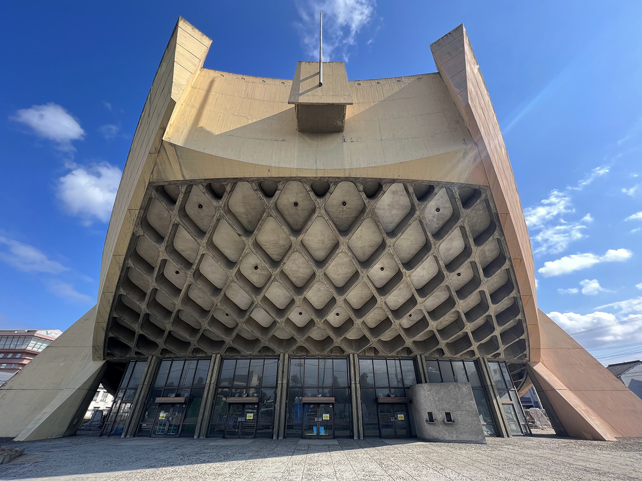 Kagawa Prefectural Gymnasium, Kenzo Tange's 'ship gymnasium' in Japan, a curved concrete structure currently under threat of demolition due to neglect