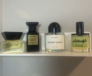 Nette the vanille, tom ford tobacco vanille, byredo desert dawn, and ds and durga pistachio perfumes on white shelf against grey wall