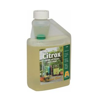 Clear bottle filled with yellow Citrox liquid and a product label with the brand name and information