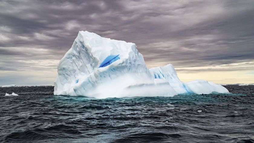 a picture of an iceberg floating in the ocean