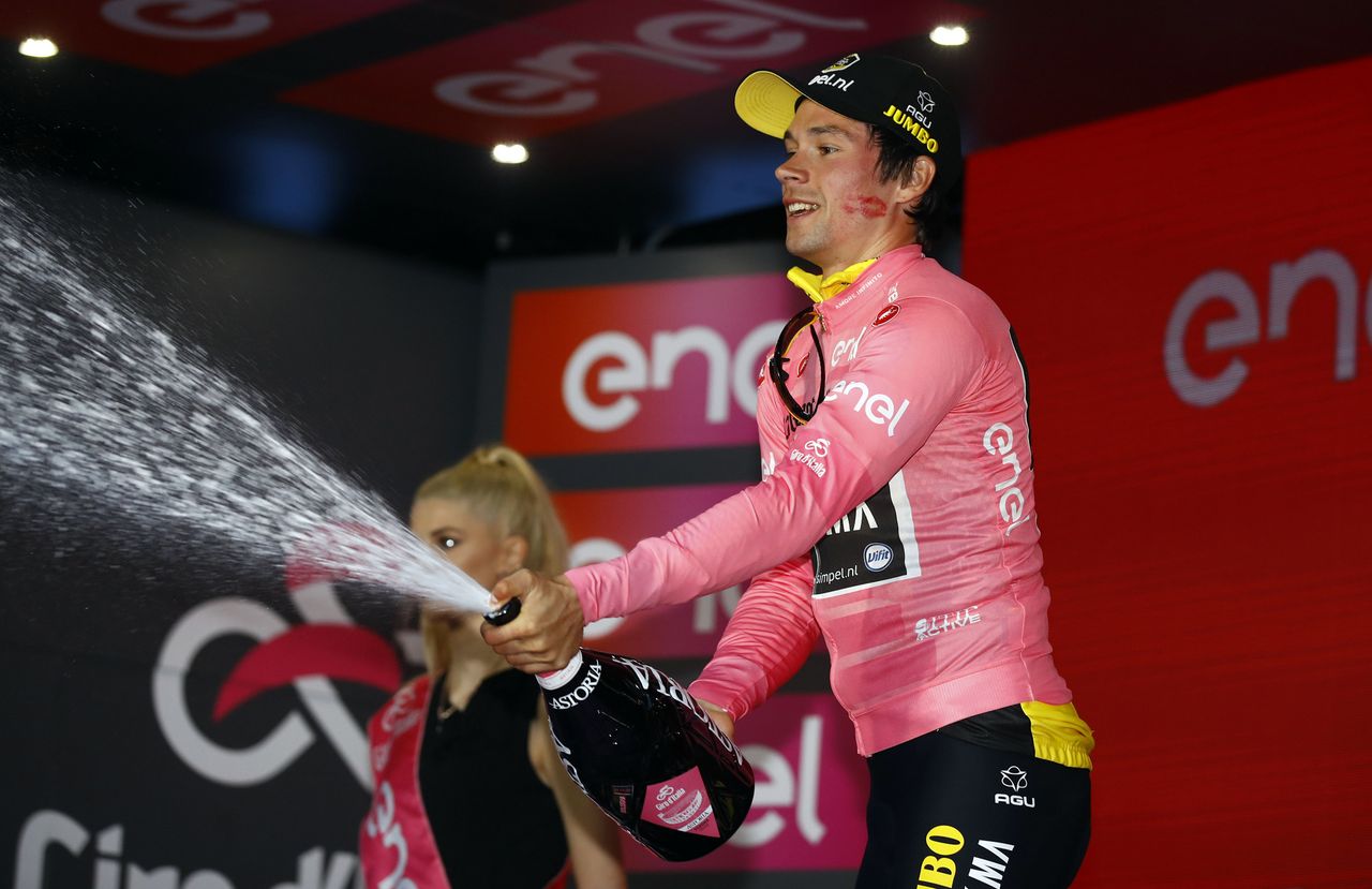 Roglic celebrates his win on the podium