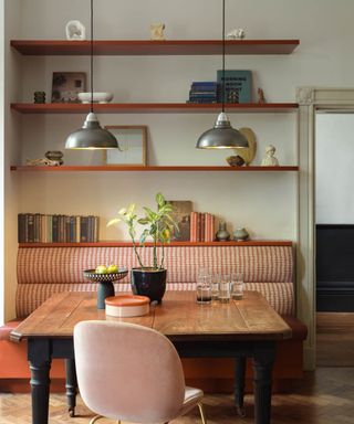 Wooden dining table with gingham sofa