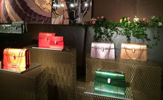 A collection of jewel-tone bags nicely displayed in a beautiful setting