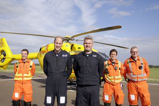 Prince William, Duke of Cambridge smiles as he poses for a photo with his colleagues before he starts his final shift with the East Anglian Air Ambulance