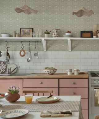 Morris & Co wallpaper in a kitchen with pink cabinets
