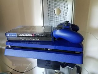 Blue Playstation 4 Slim with controller, Uncharted, and The Last Guardian Hero